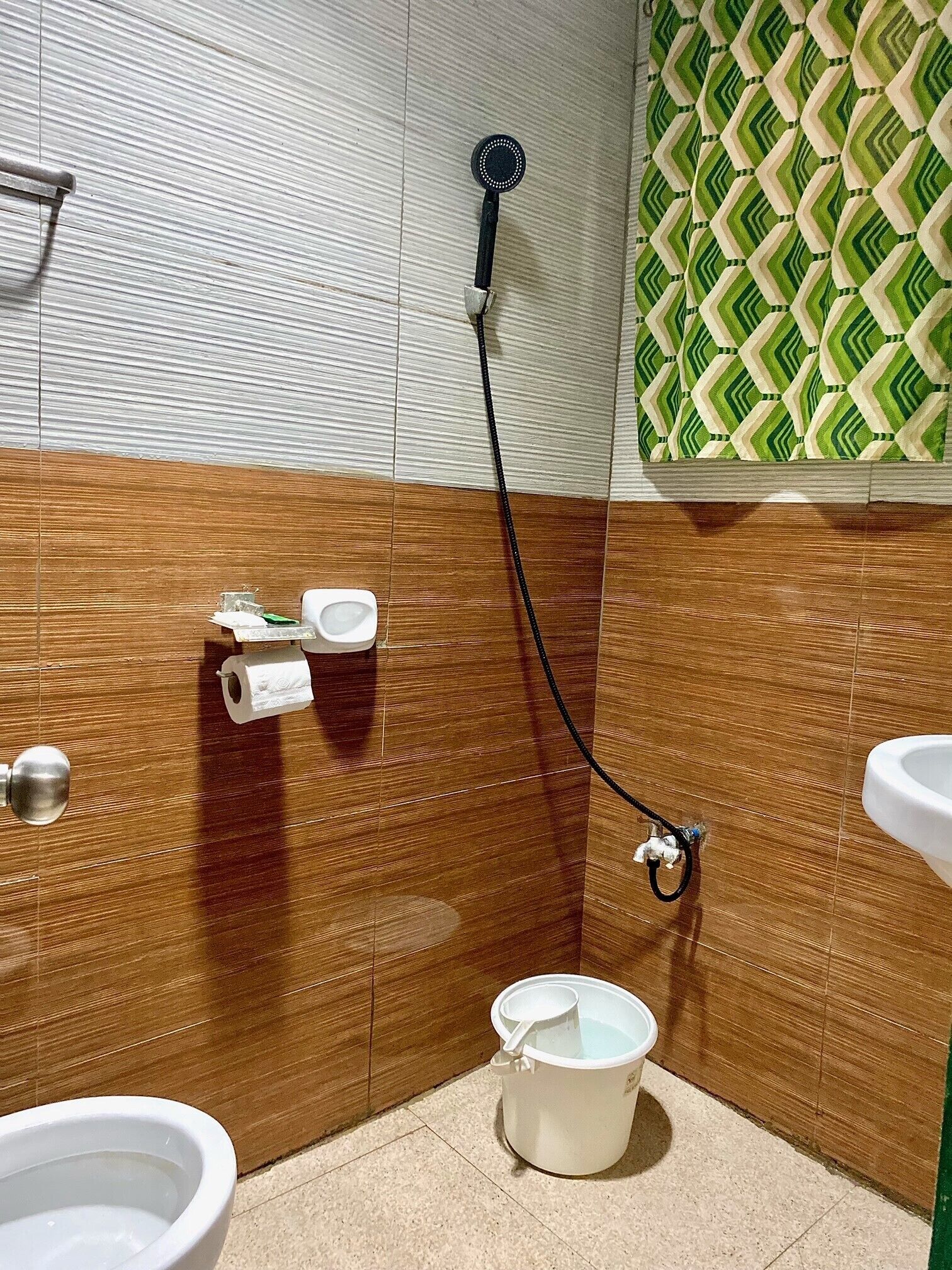 A bathroom with a shower, toilet, and sink.