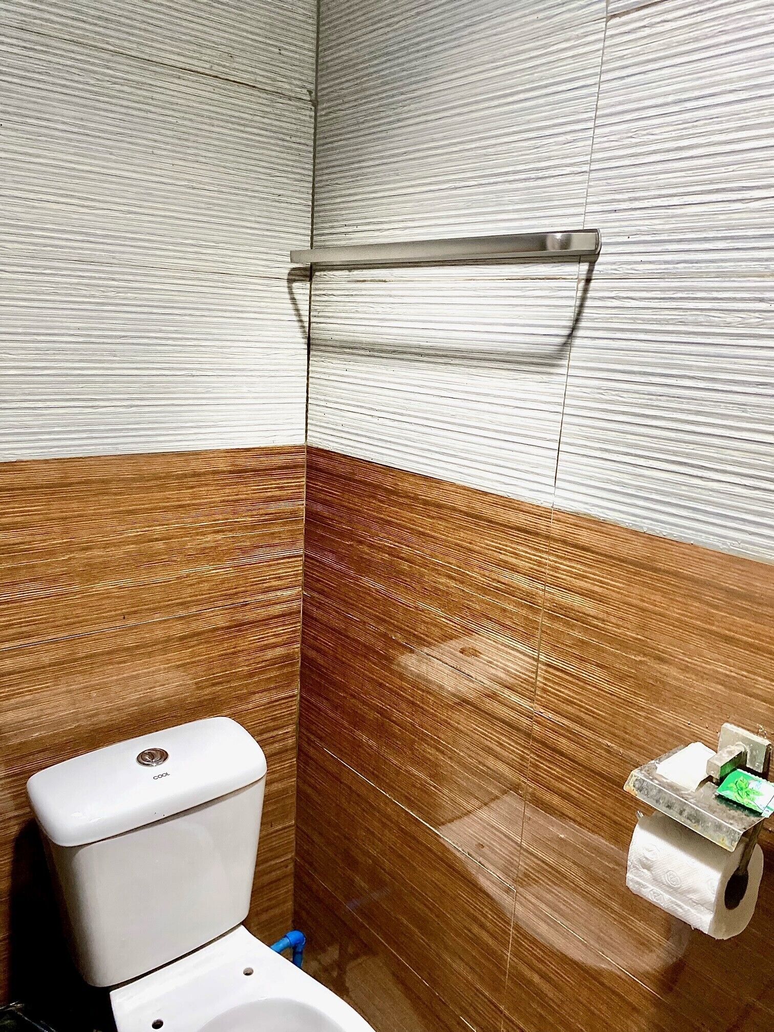 A bathroom with a toilet, a sink, and a shower area.