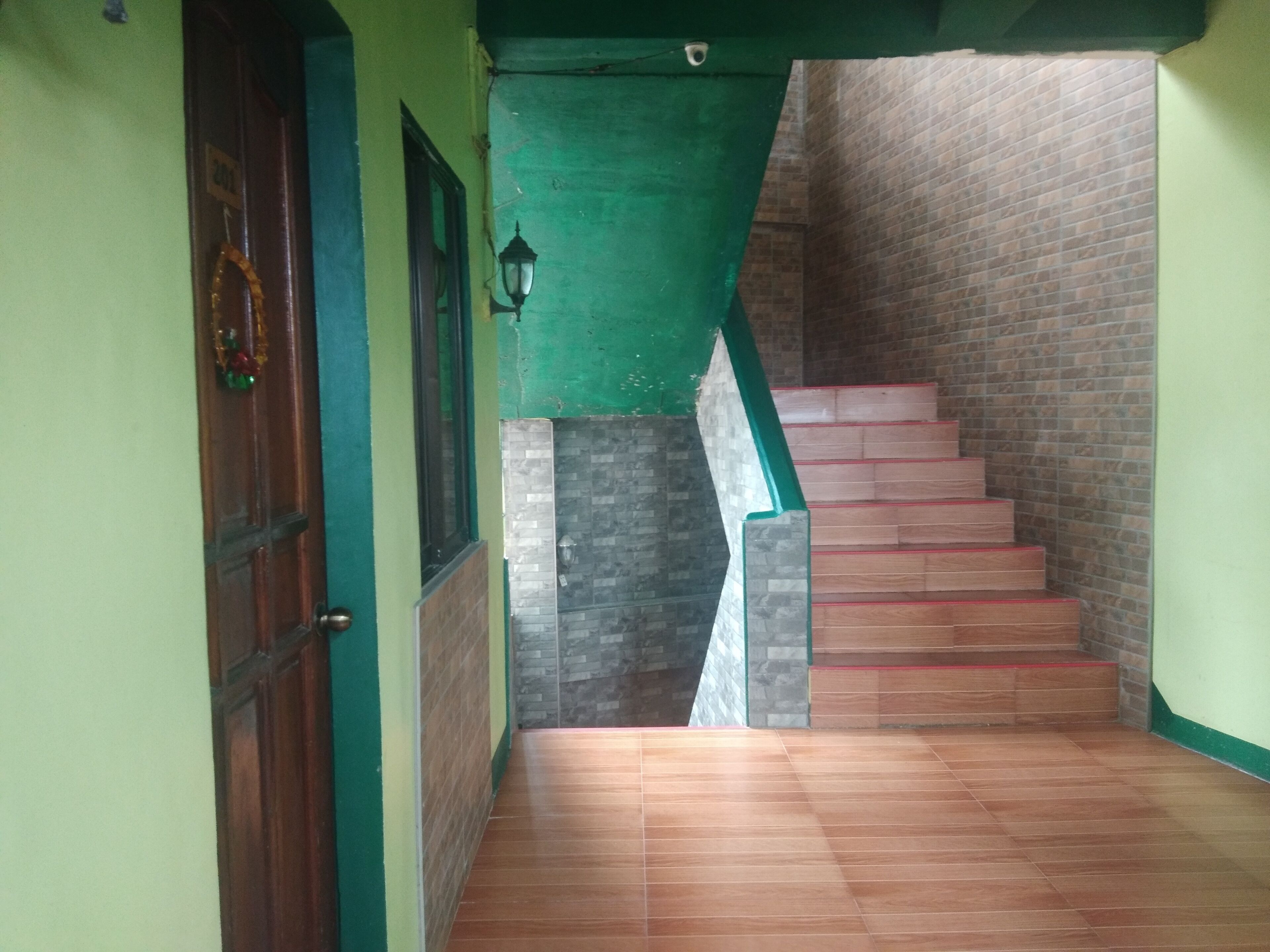 A staircase with wooden steps and a green wall.