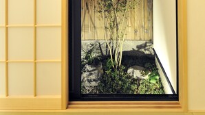 Una habitación japonesa tradicional con un fusuma que da a un pequeño jardín.