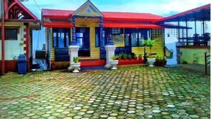 A building with a red roof and a sign that reads "RESORT".