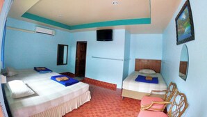 A hotel room with two beds, a TV, a mirror, and a painting on the wall. - Somjainuk Resort 2 (Pluak Daeng)