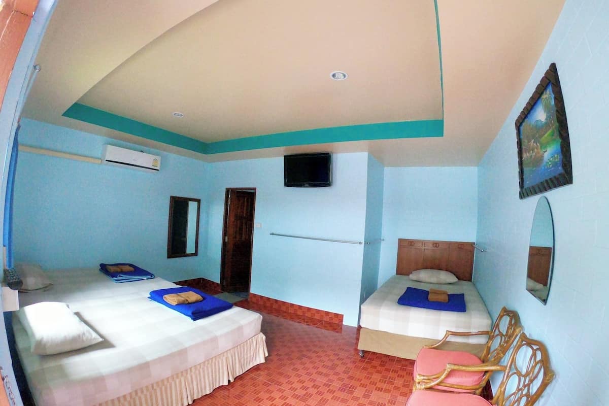 A hotel room with two beds, a TV, a mirror, and a painting on the wall.