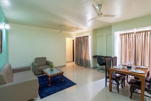 Family Apartment, 2 Bedrooms, City View | Living area | Flat-screen TV, fireplace - StayBird Icon Bliss, An Apartment Hotel (Pune)