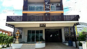 A two-story building with a prominent 'R.M.' sign on the upper level. - R.M. Mansion Surin (Surin)