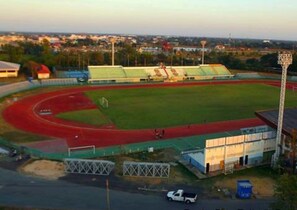 A stadium with a running track, a soccer field, and a basketball court. - R.M. Mansion Surin (Surin)