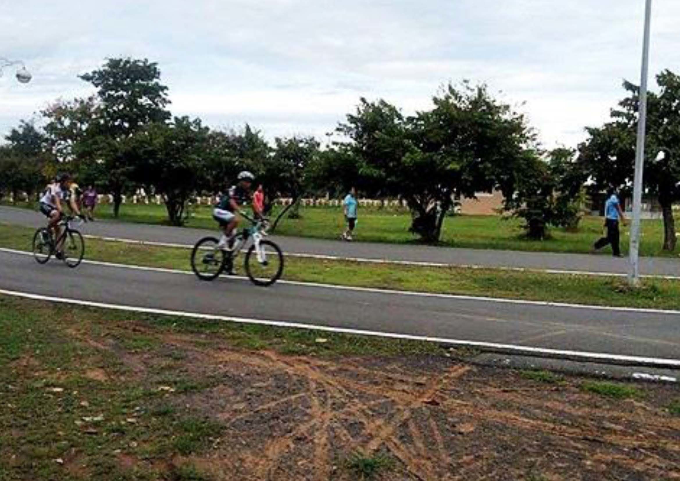 A paved path with cyclists and pedestrians.