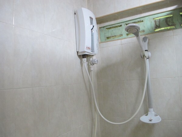 A bathroom with a white shower unit mounted on a tiled wall. - Phuendernthang Resort (Tha Chang)