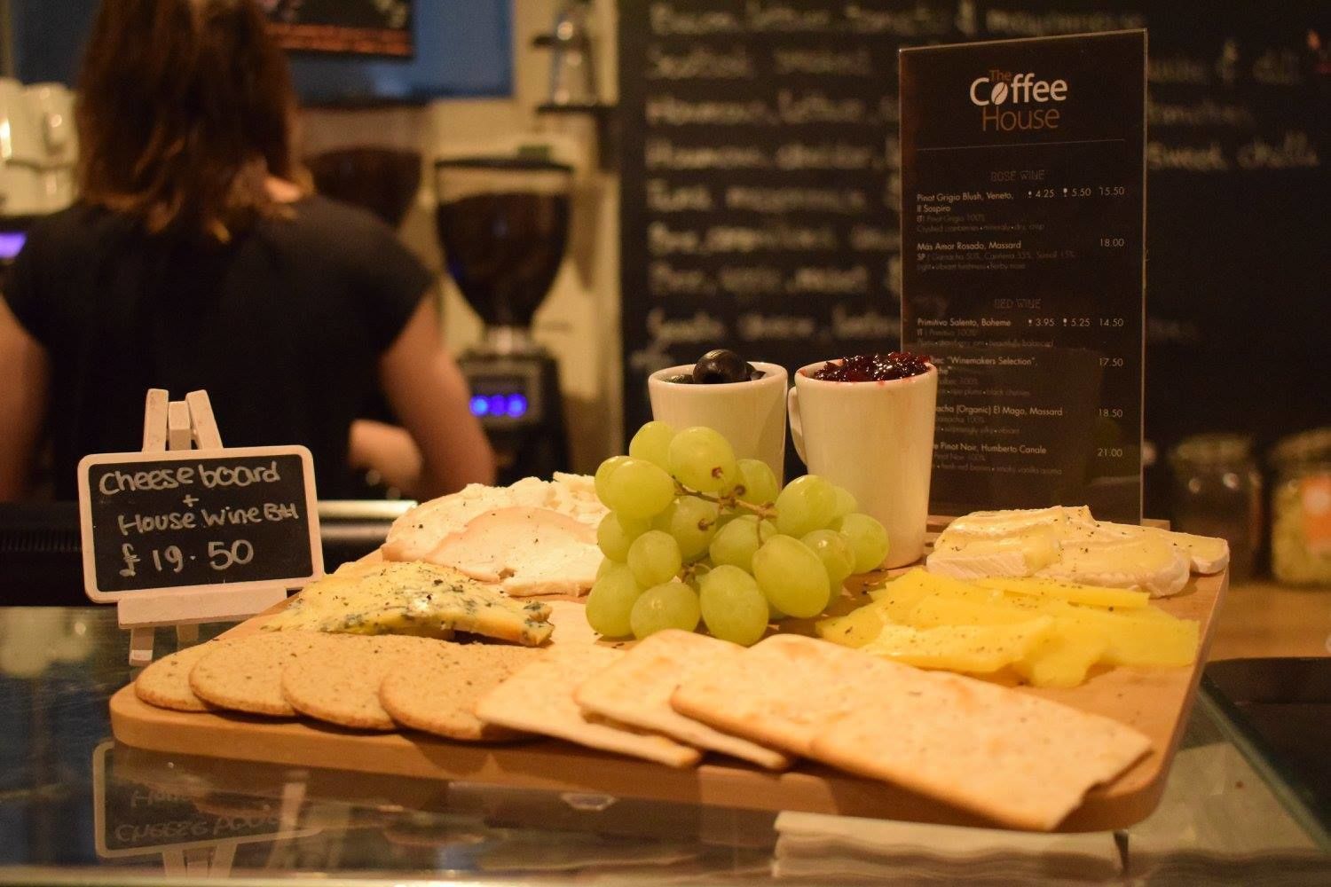 A cheese board with various cheeses, grapes, and crackers, priced at £19.50.
