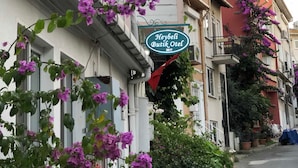 A building with a sign reading "Heybeli Butik Otel 2017" and purple flowers in front. - Heybeli Butik Hotel (Adalar)