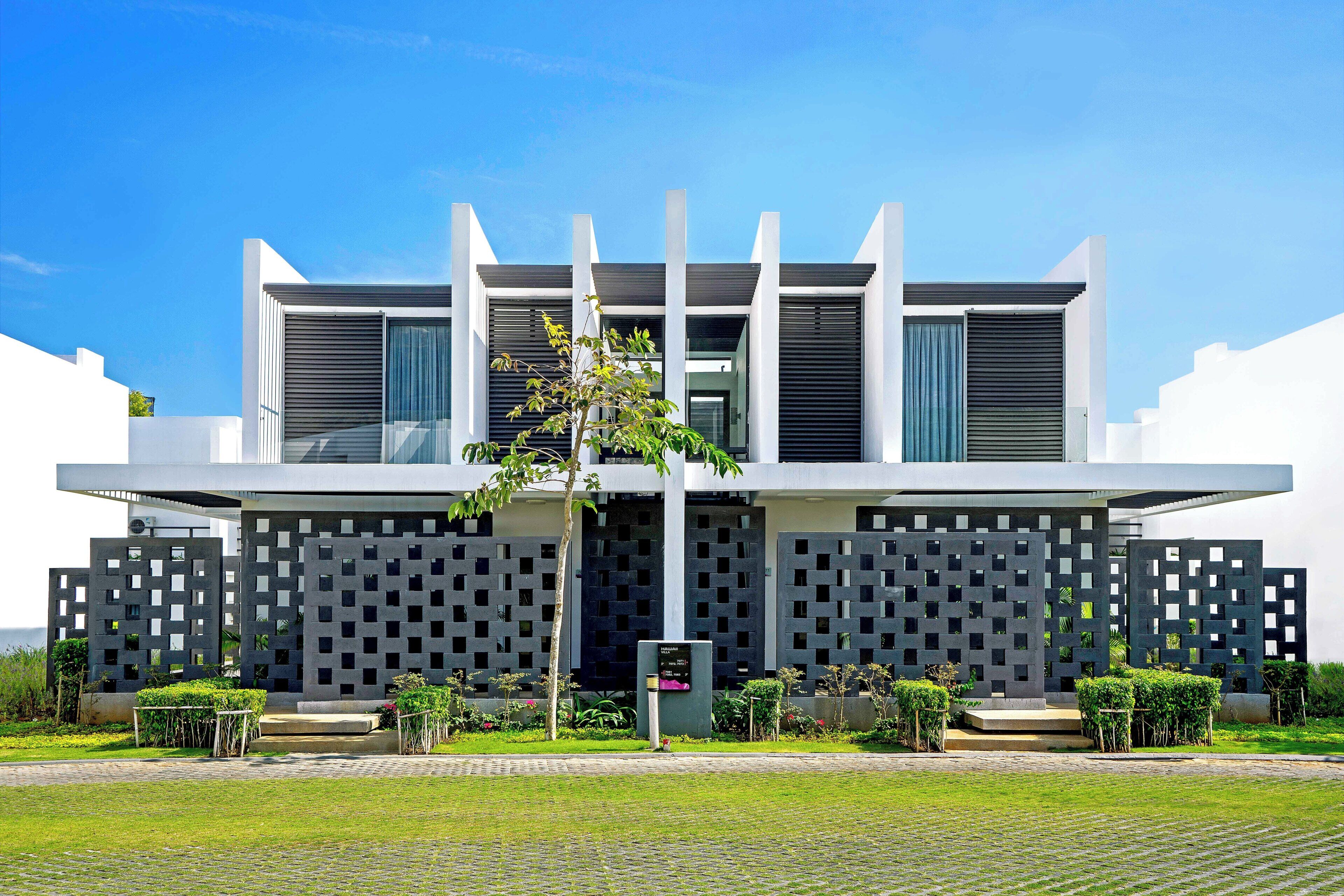 A modern building with a symmetrical facade, large windows, and a central entrance.