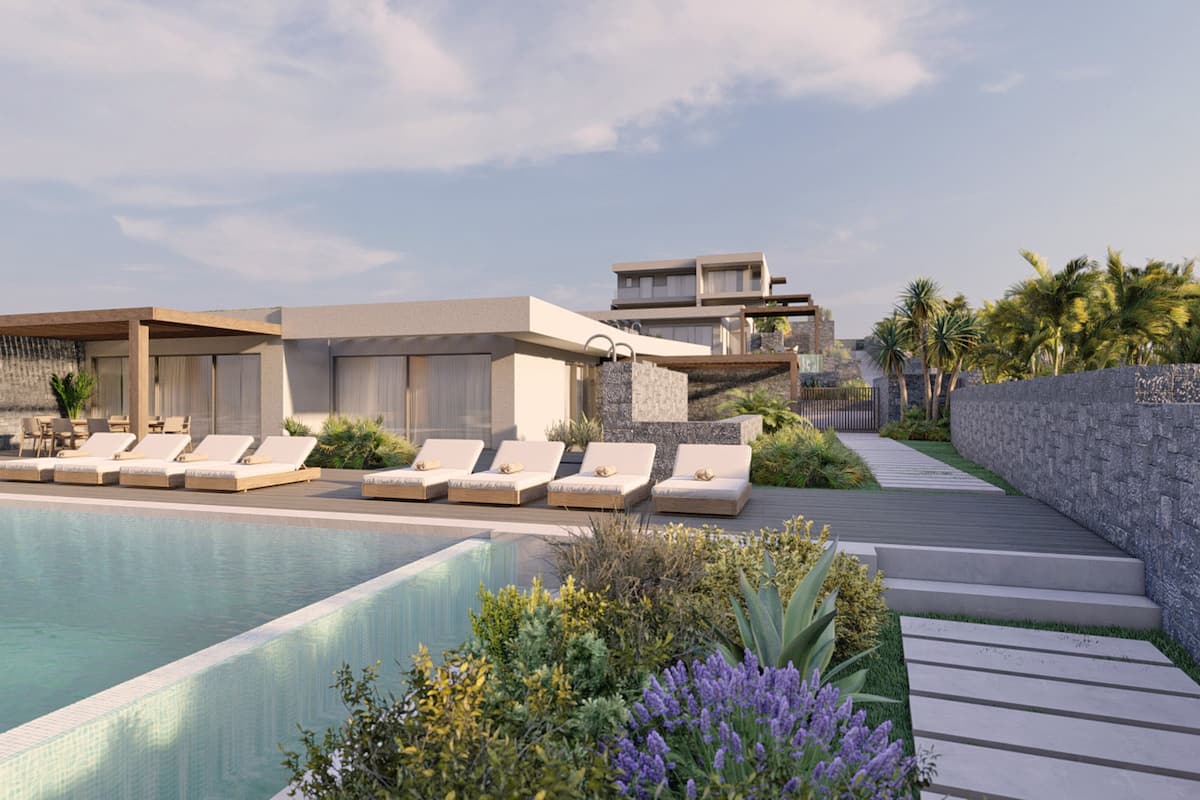 A modern resort with a swimming pool, sun loungers, and a landscaped garden.