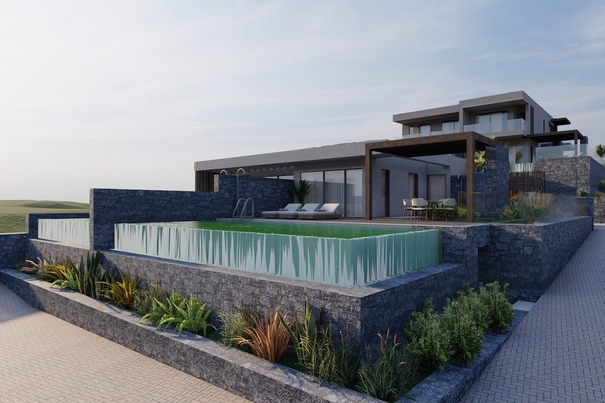 A modern house with a swimming pool, outdoor seating, and a stone facade.