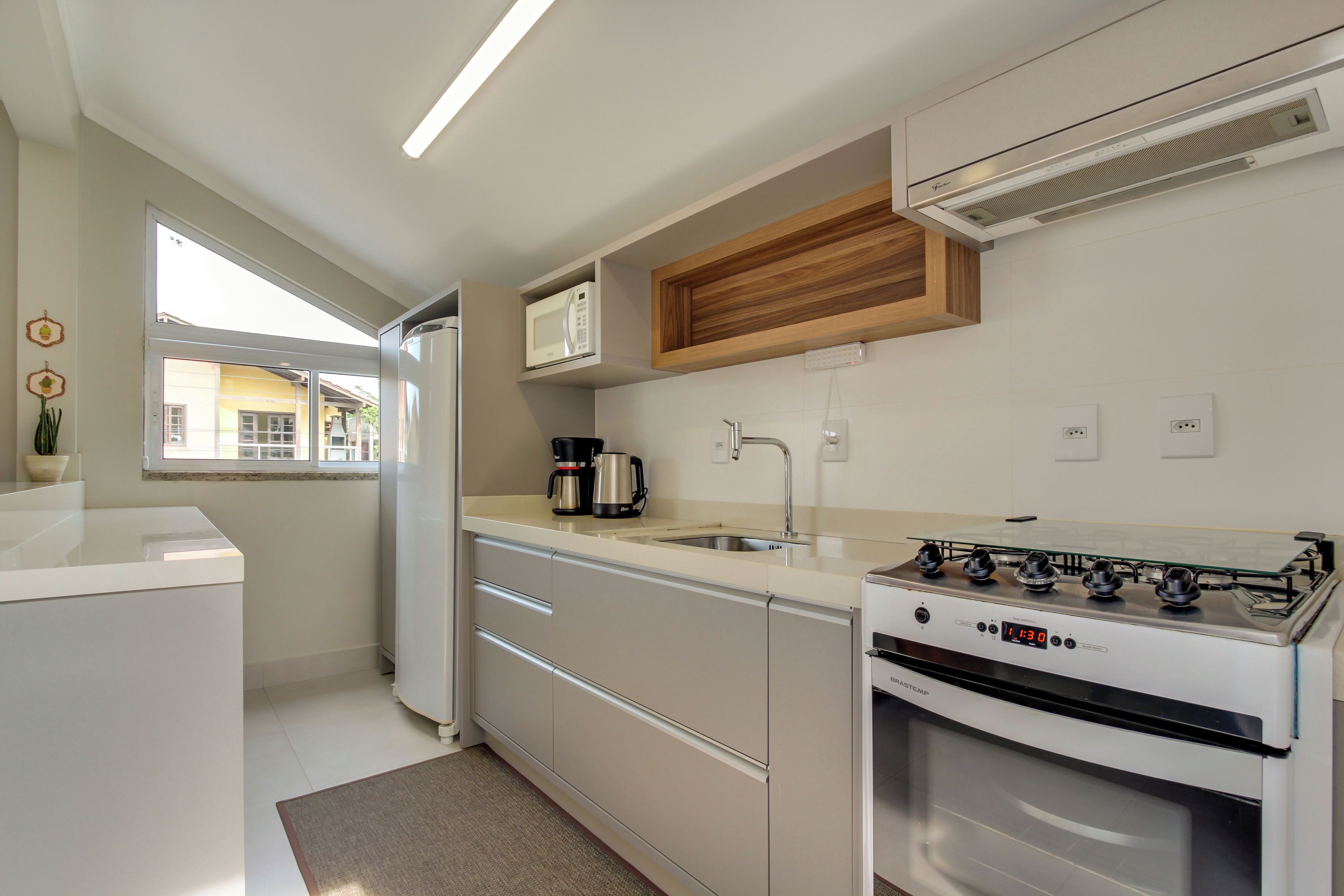 A modern kitchen with a built-in microwave, stove, and sink.