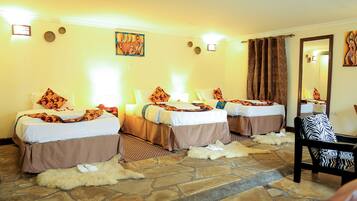 A hotel room with three beds, stone flooring, and a mirror.
