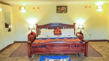 A wooden bed with two bedside tables, a patterned bedspread, and a decorative pillow.