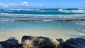 A beach with clear blue water, waves, and rocky outcrops. - Hotel Alegria (Cabarete)