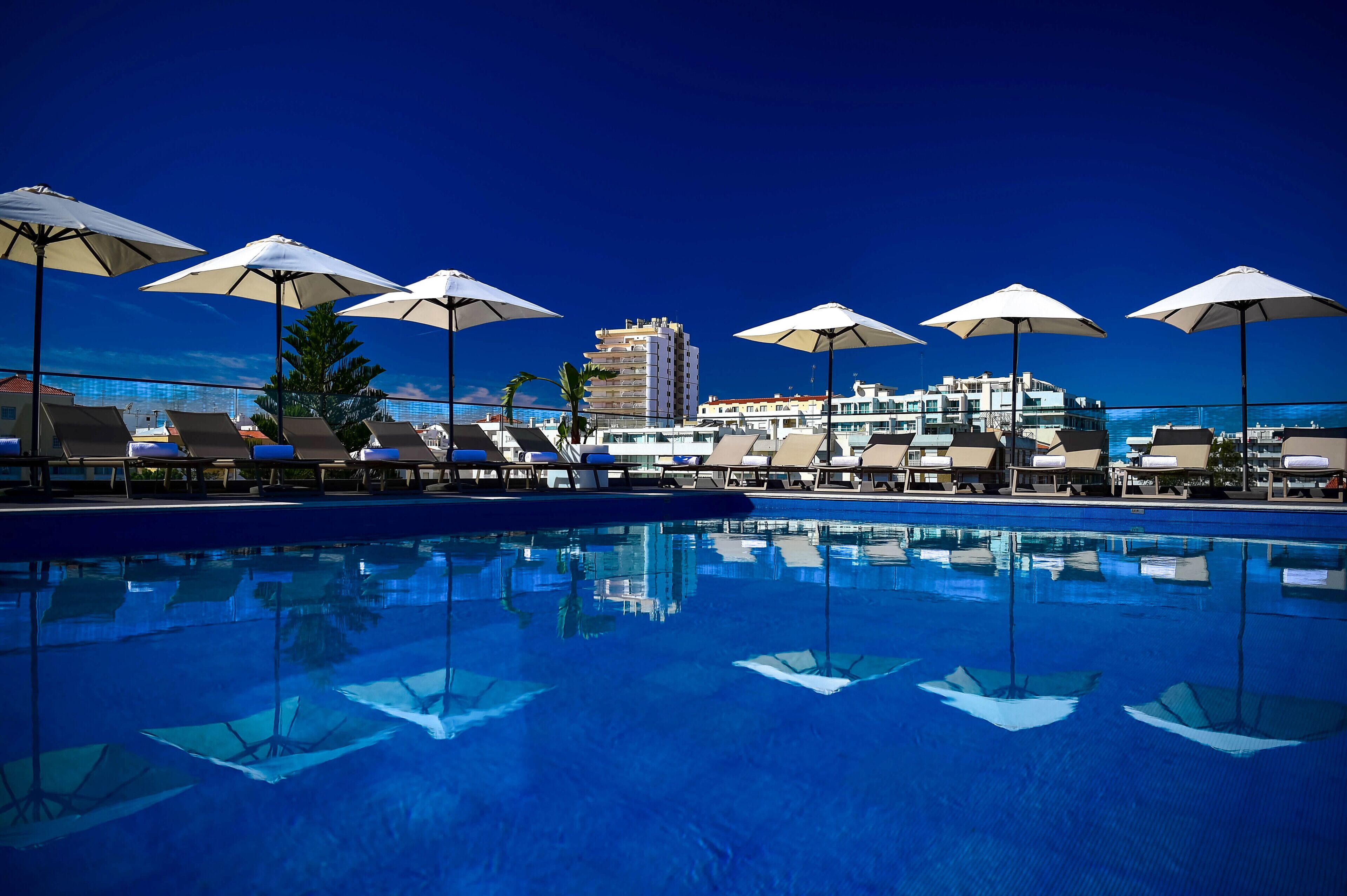 indoor pool, outdoor pool, pool umbrellas, pool loungers