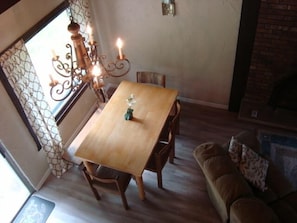 Enjoy meals in this cozy dining area with a brick fireplace and comfortable seating for four.