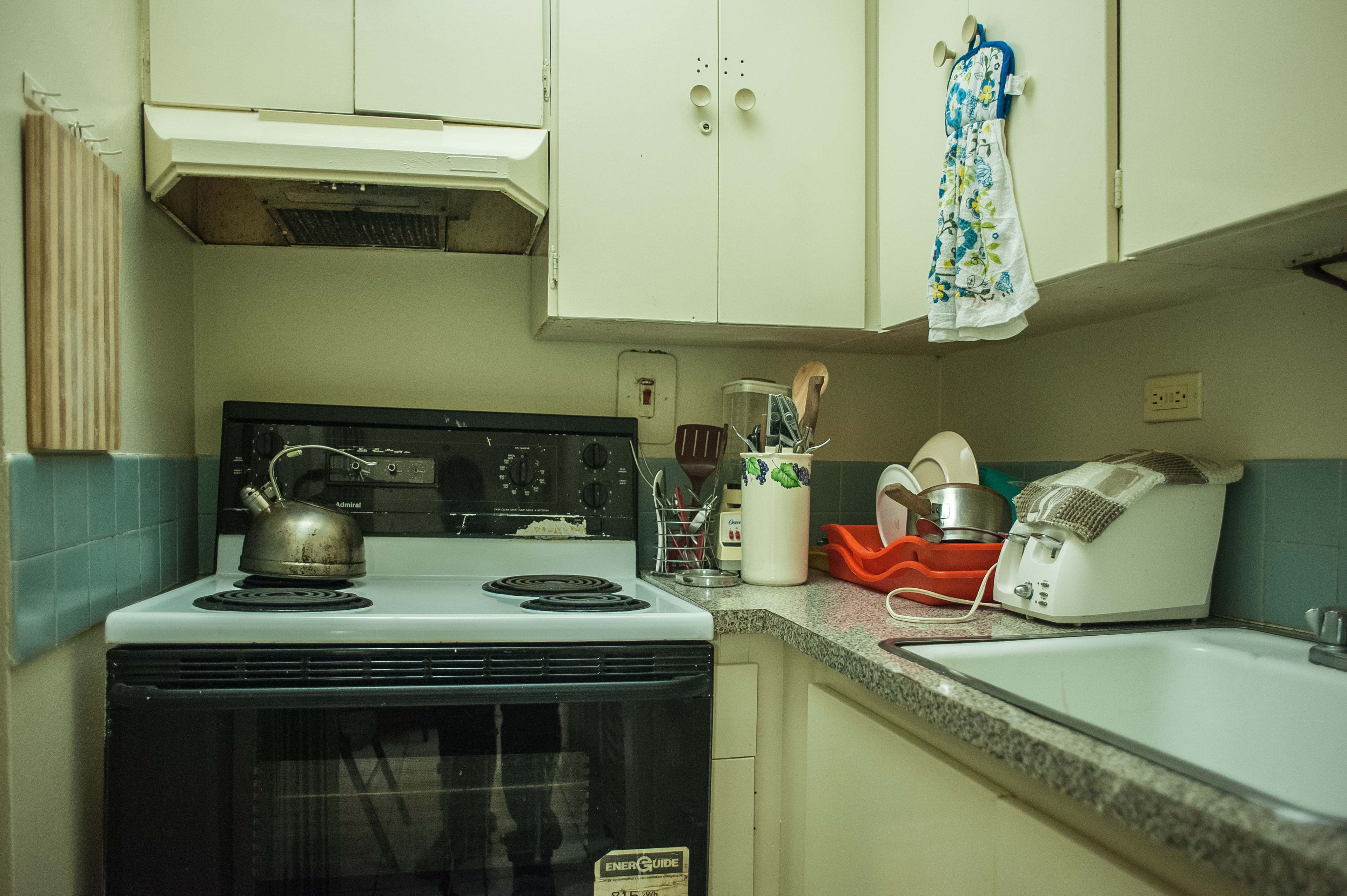 A kitchen with a stove, oven, and sink.
