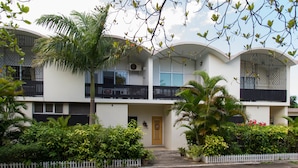 A two-story building with a white facade, balconies, and a gated entrance. - Montego Bay Club Beach Resort (Montego Bay)