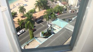 An aerial view of a beach with palm trees, a parking lot, and buildings. - Montego Bay Club Beach Resort (Montego Bay)