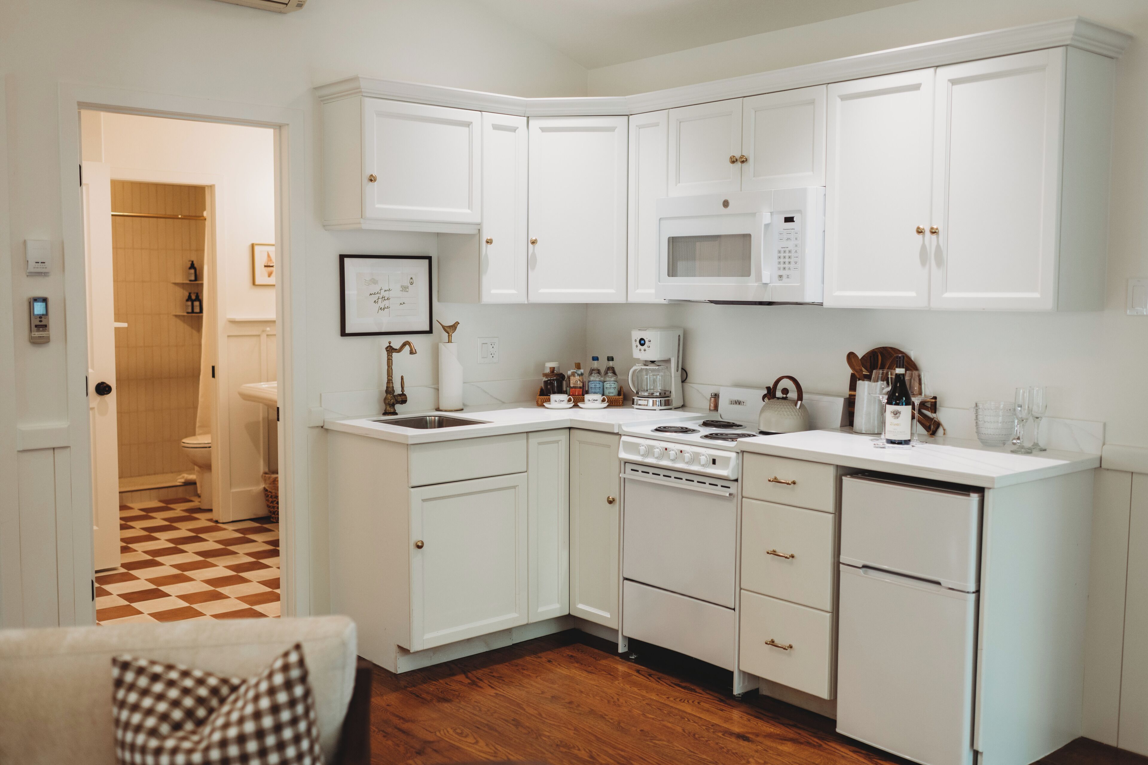 A kitchen with white cabinetry, a microwave, a stove, and a dishwasher.