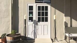 A building entrance with a sign reading "Entrance to Workshops."