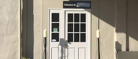 A building entrance with a sign reading "Entrance to Workshops."
