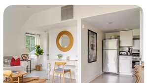 A modern interior with a dining area, kitchen, and living space.