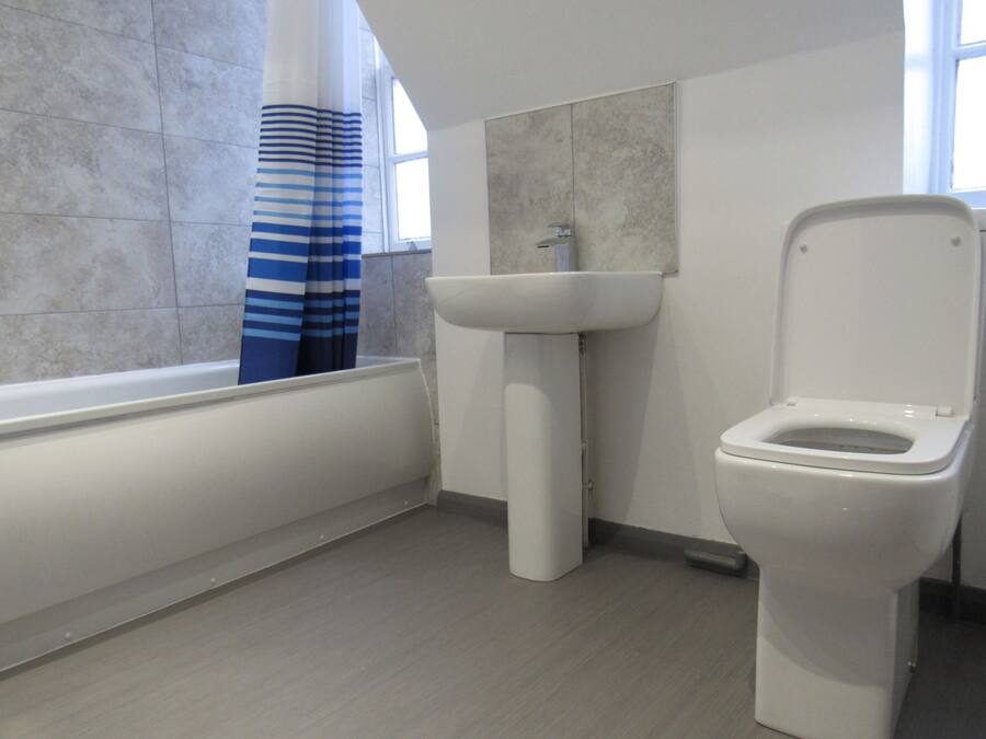 A bathroom with a bathtub, a sink, and a toilet.
