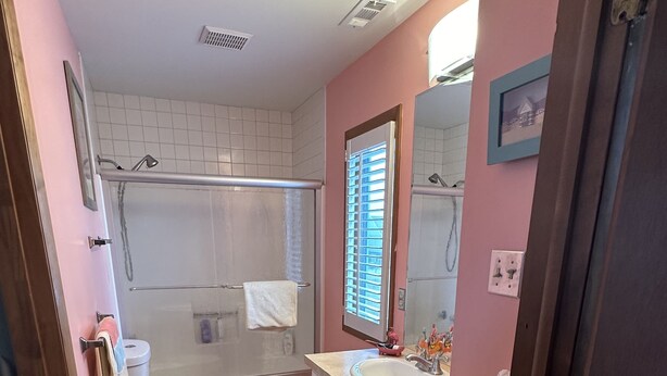A bathroom with a shower, toilet, and sink. - Private Canalfront House, Dock, Deck, Fire Pit, Parking, 7th house to the Beach (South Bethany Beach)