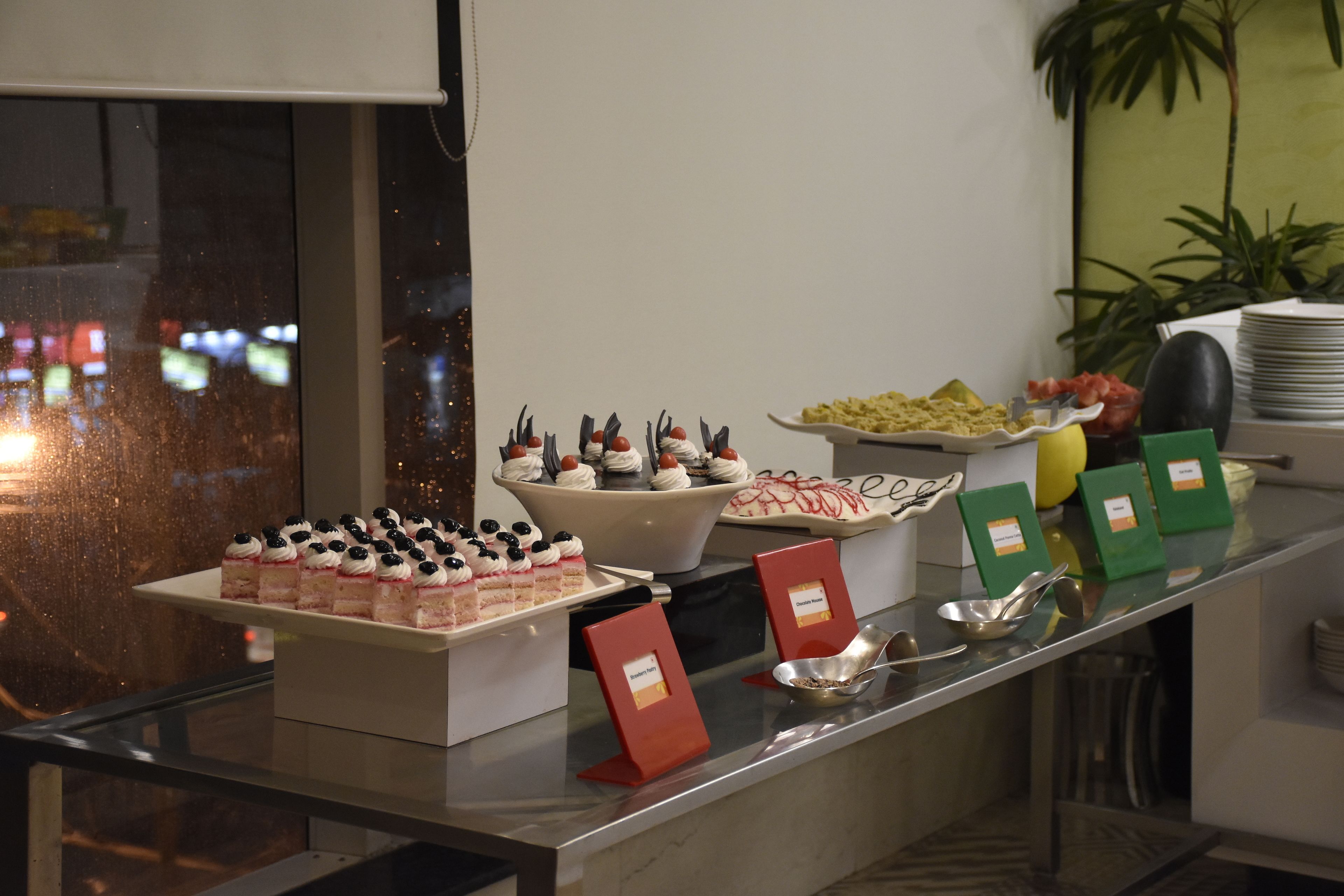 A buffet with various food items and serving utensils.