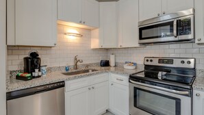 A modern kitchen with white cabinets, a stainless steel dishwasher, a built-in microwave, and an oven. - The Kearney♥Accessibility Features♥Free Parking/W+D/Family Friendly/Ensuites (Nashville)