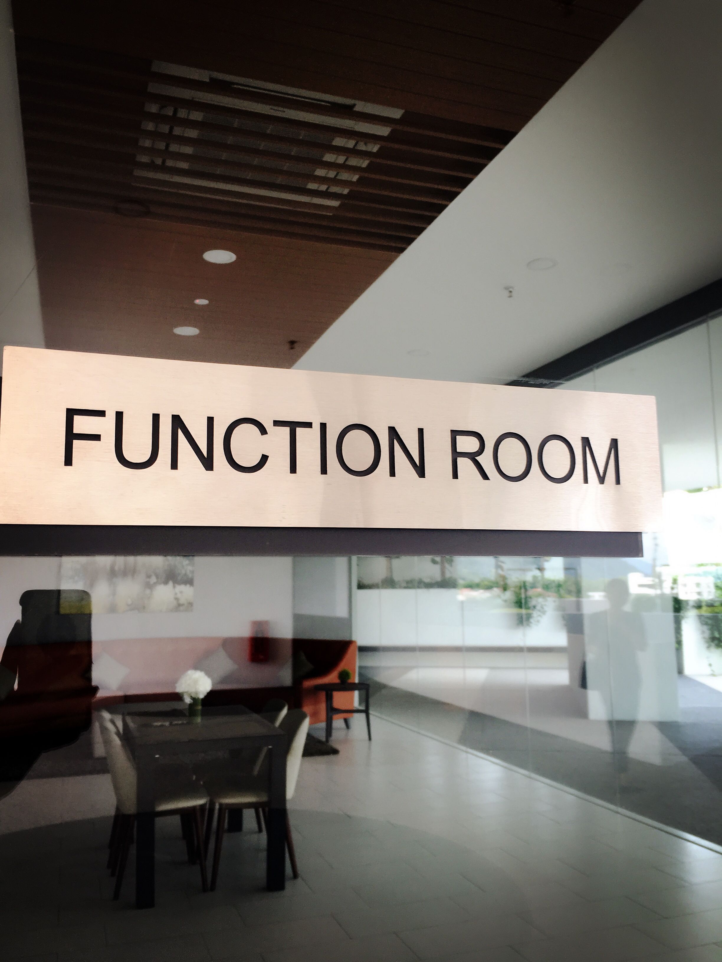 A modern function room with a large sign reading "FUNCTION ROOM".