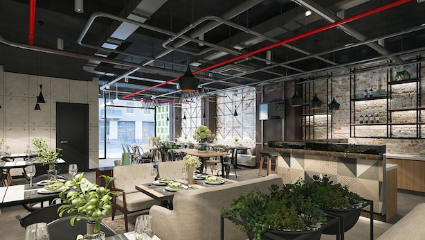 A modern restaurant with high ceilings, exposed ductwork, and a mix of brick and concrete walls. Tables are set with green tablecloths and potted plants. - Ale Nhatrang Hotel (Nha Trang)