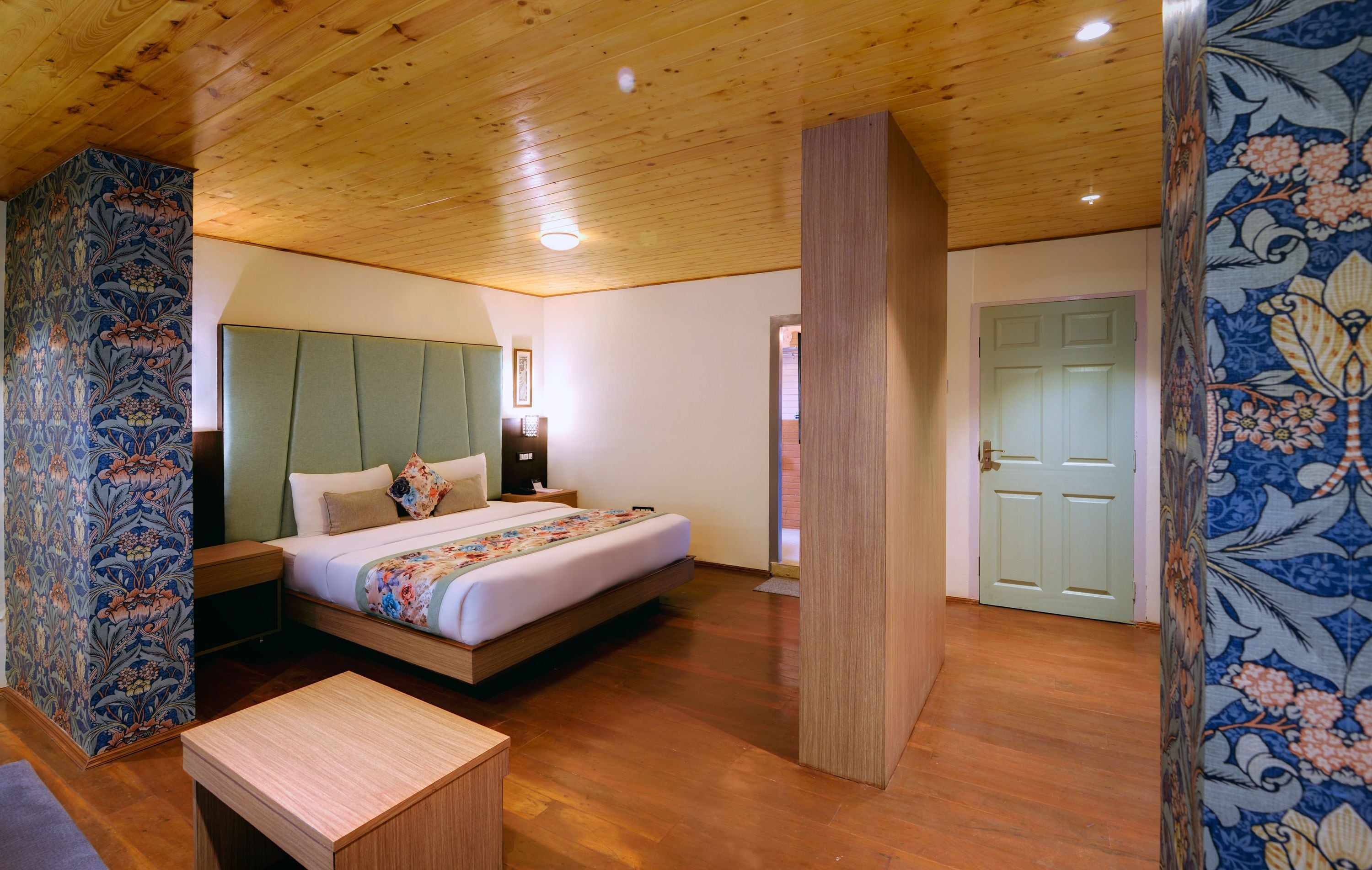 A bedroom with a bed, bedside table, and a nightstand.