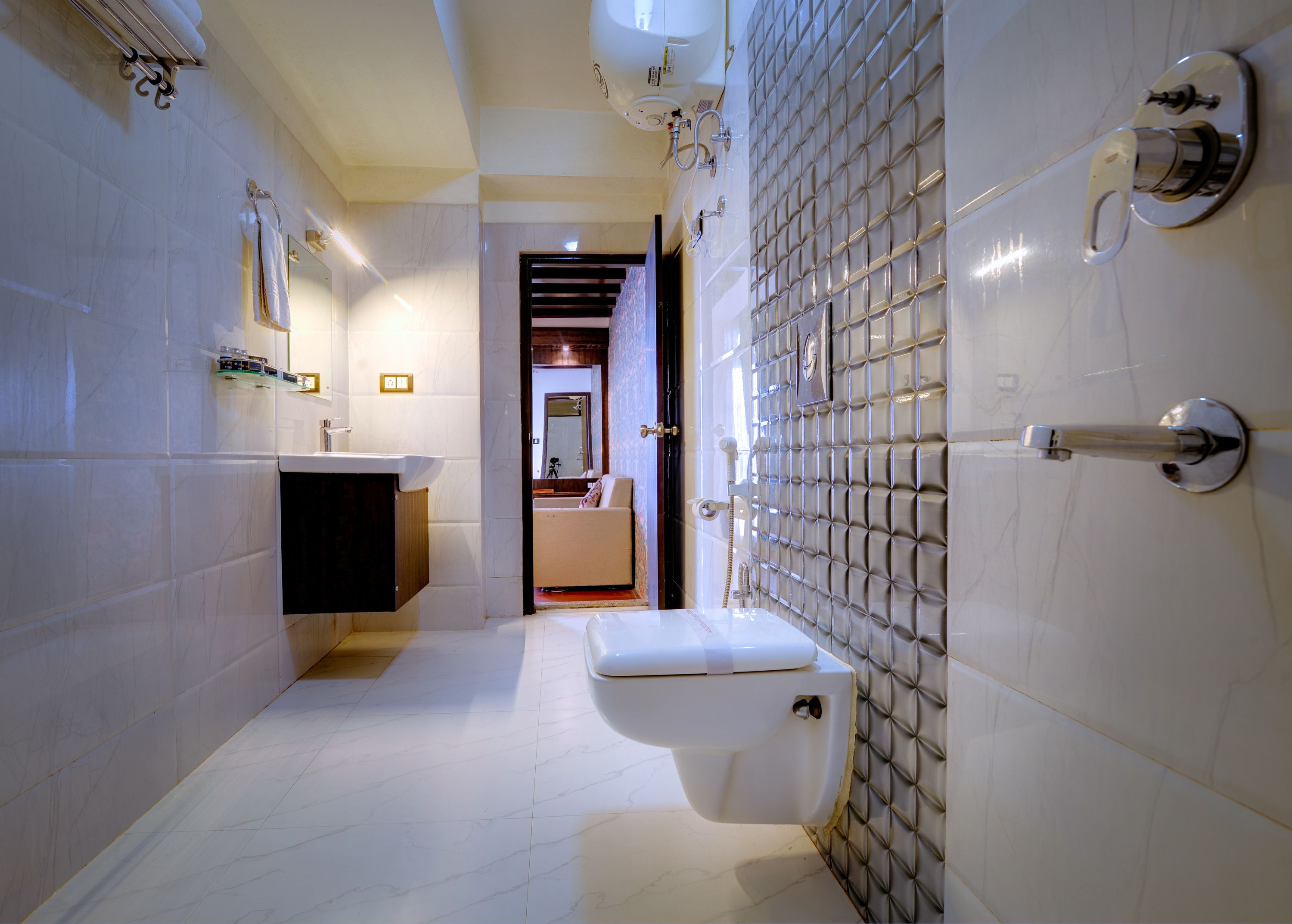 A modern bathroom with a toilet, sink, and shower area.