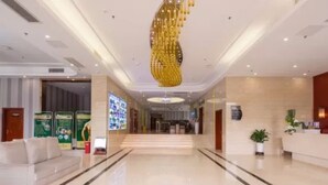 A modern hotel lobby with a marble floor, a reception desk, and a large chandelier. - Guilin Manhattan Hotel North Station (Guilin)