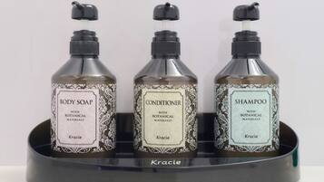 Three bottles of Kracie body care products in a black holder.