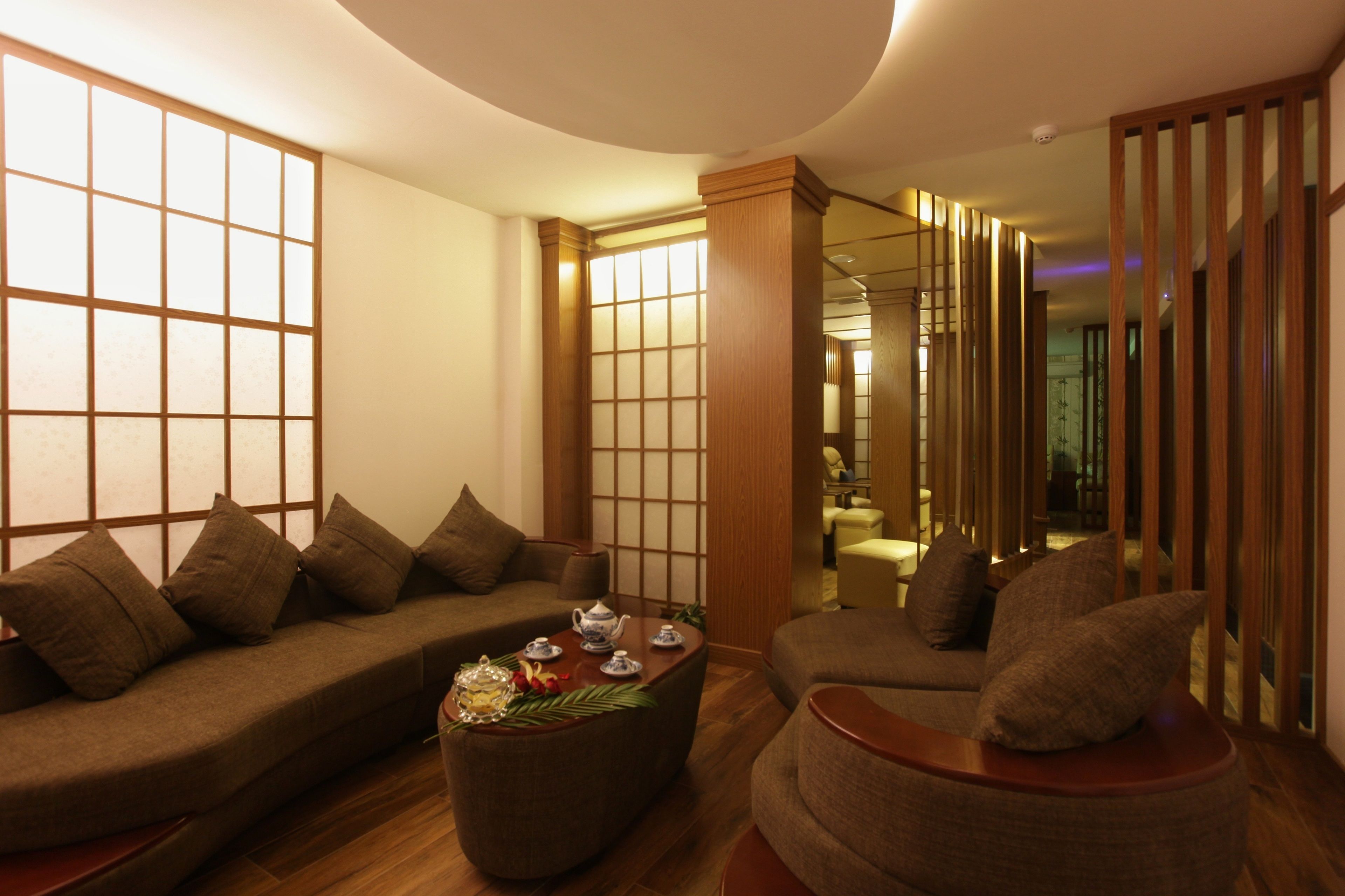 A modern living room with a sofa, armchair, and coffee table.