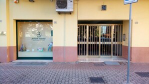 A building entrance with a glass door and a sign reading "NATUR HOUSE." - LovelyBed (Aprilia)