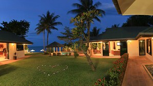 A hotel with two-story buildings, a pool area, and a heart-shaped flower arrangement on the lawn. - 5 Bedroom Beachfront Villa SDV100-By Samui Dream Villas (Koh Samui)