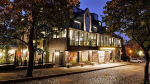 A modern hotel with a two-story structure, large windows, and a well-lit entrance. - All Seasons Residence Hotel (Sofia)