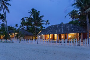 On the beach, white sand, sun loungers, beach umbrellas