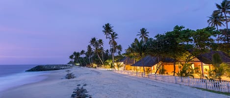 On the beach, white sand, sun loungers, beach umbrellas