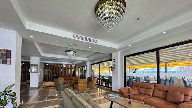 A spacious lobby with a modern chandelier, comfortable seating, and large windows offering views of the outside. - Villa Vanilla Hotel  (Istanbul)