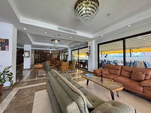 A spacious lobby with a modern chandelier, comfortable seating, and large windows offering views of the outside. - Villa Vanilla Hotel  (Istanbul)