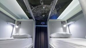 A bunk room with two beds, a skylight ceiling, and a window. - Stay Inn Taksim Hostel (Istanbul)