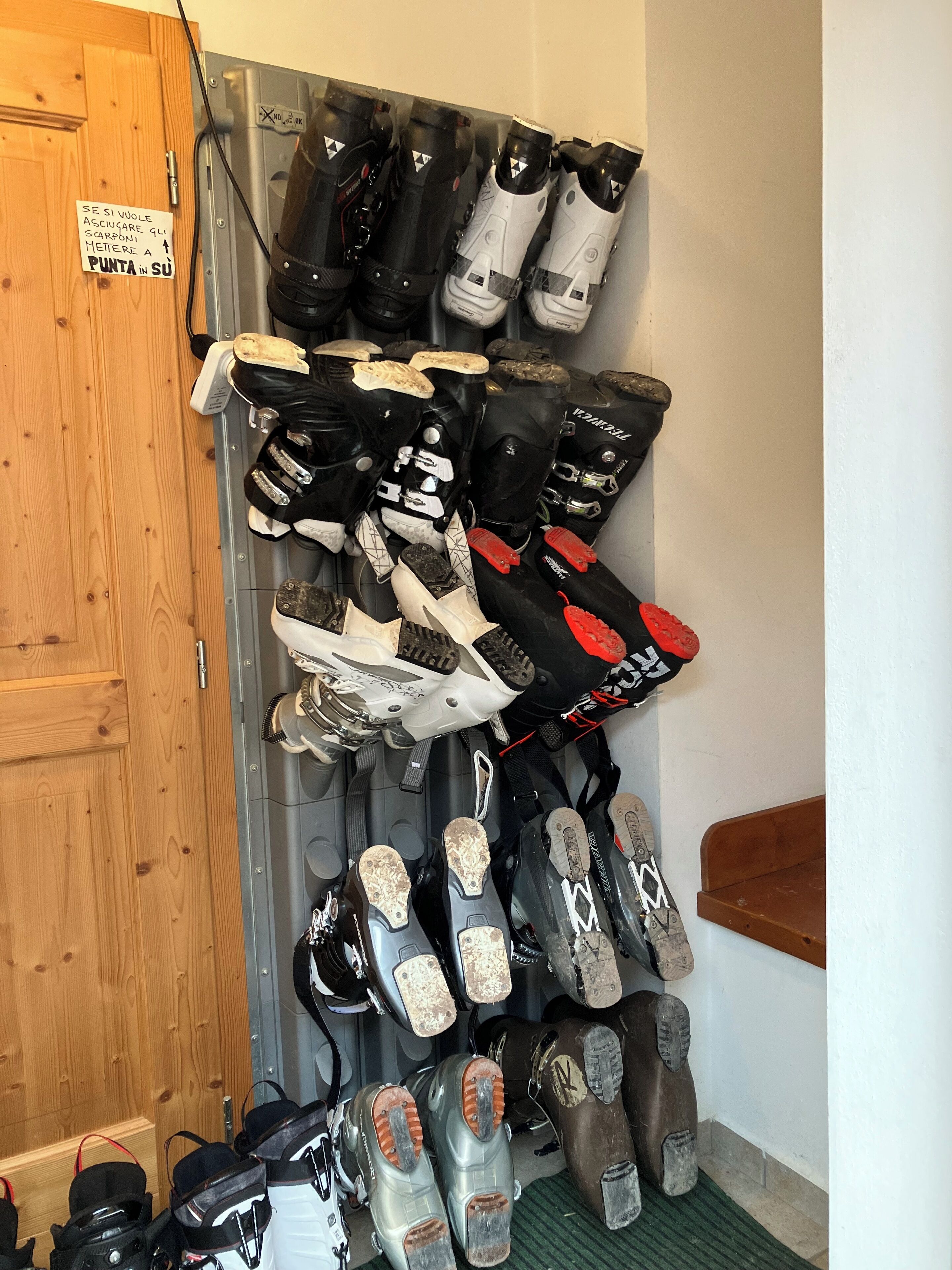 A storage rack with multiple pairs of ski boots.